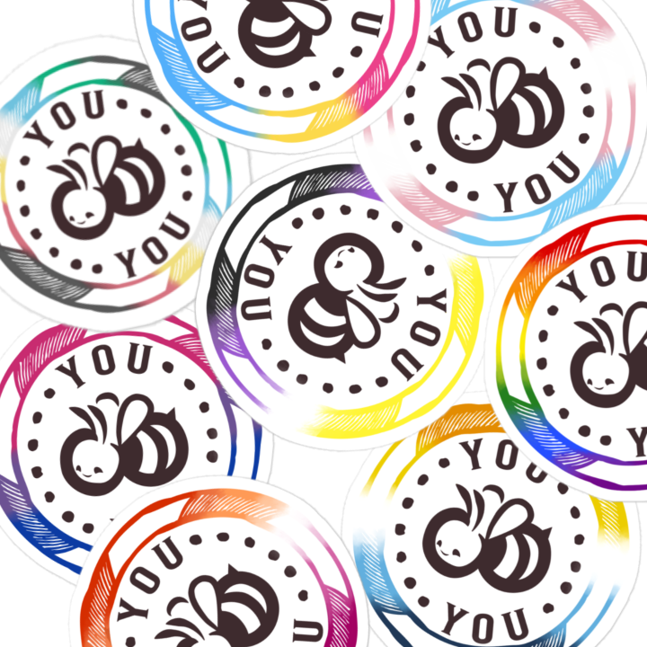A cluster of round stickers featuring a black bee illustration and the text 'YOU' in a circular design, each with a different PRIDE color rainbow borders