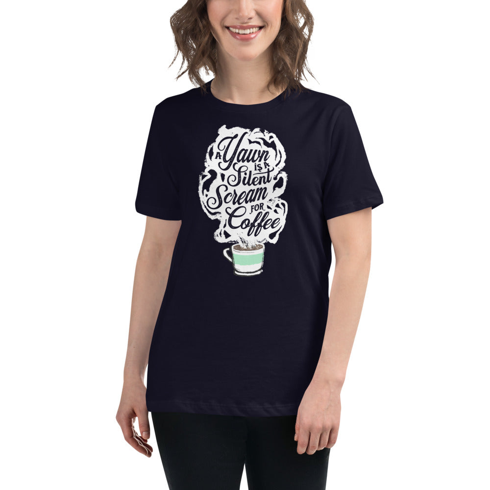 Image of brunette white woman wearing Navy blue Fem relaxed fit Tee with White coffee cup with green stripe filled with hot coffee that is releasing white steam. "A Yawn is a Silent Scream for Coffee" written in the steam.