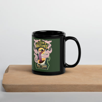 Black mug with a colorful design on a wooden surface