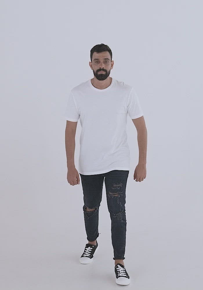 MASC FIT: Video of man of medium build with dark hair and beard wearing ripped jeans showing the fit of the masc fit shirt. crew neckline style, sleeves hem long but still above the elbow, tapered fit to give tailored look. 