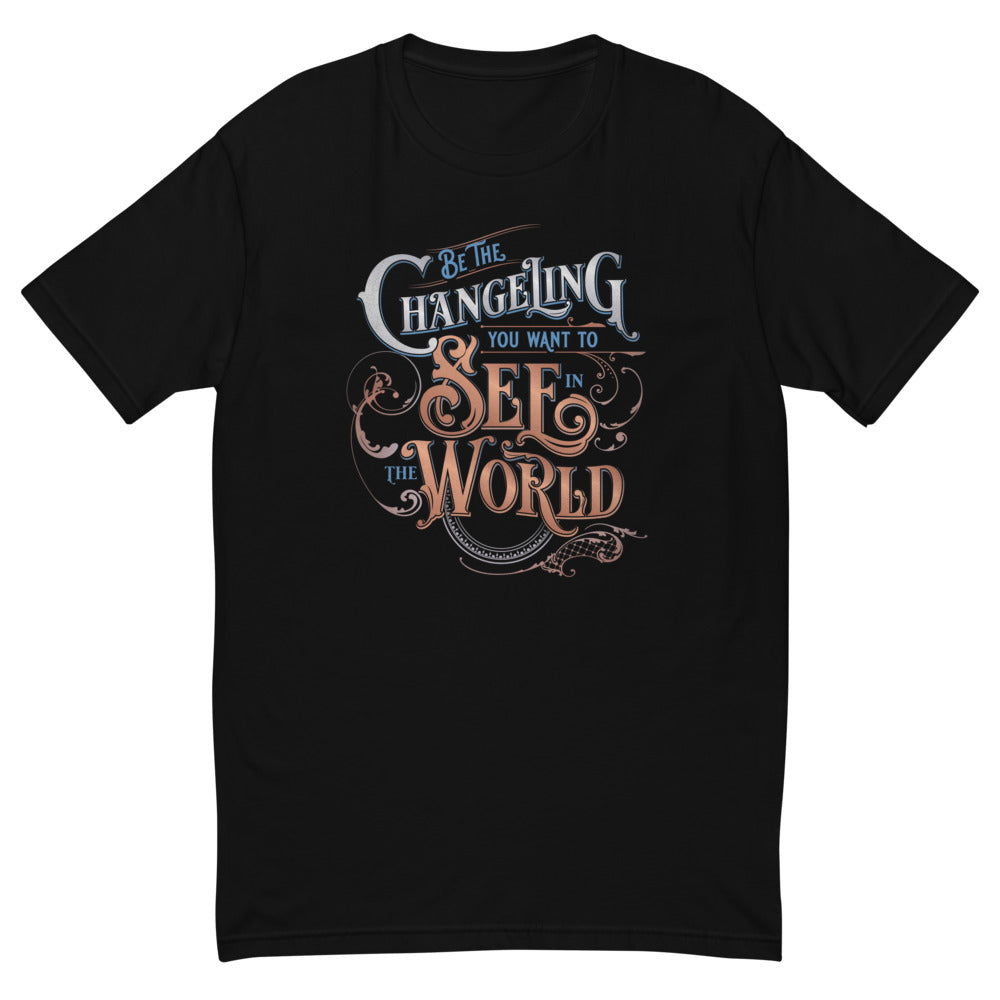 Black Masc fit Tee with “Be the Changeling you want to see in the world” in silver, bronze and blue lettering surrounded by intricate decals