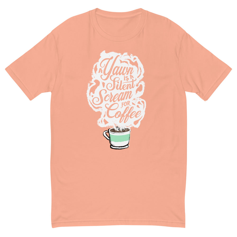 Desert Pink Masc fit Tee with White coffee cup with green stripe filled with hot coffee that is releasing white steam. "A Yawn is a Silent Scream for Coffee" written in the steam. 