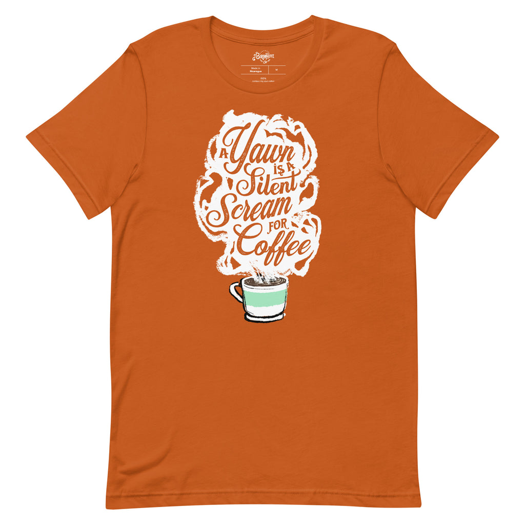 Autumn (earthy orange) Unisex fit Tee with White coffee cup with green stripe filled with hot coffee that is releasing white steam. "A Yawn is a Silent Scream for Coffee" written in the steam. 