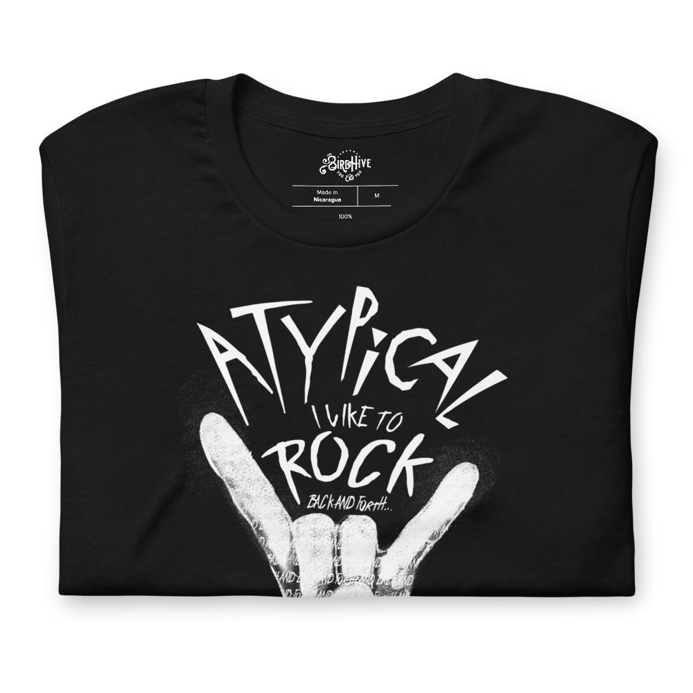 folded Black unisex fit tee with design “Atypical, I like to ROCK” in smaller font “back and forth”. Painting of a white hand making the ROCK symbol. Inside the shading of the hand words continue saying “back and forth and back and forth and back and forth…” repeated.