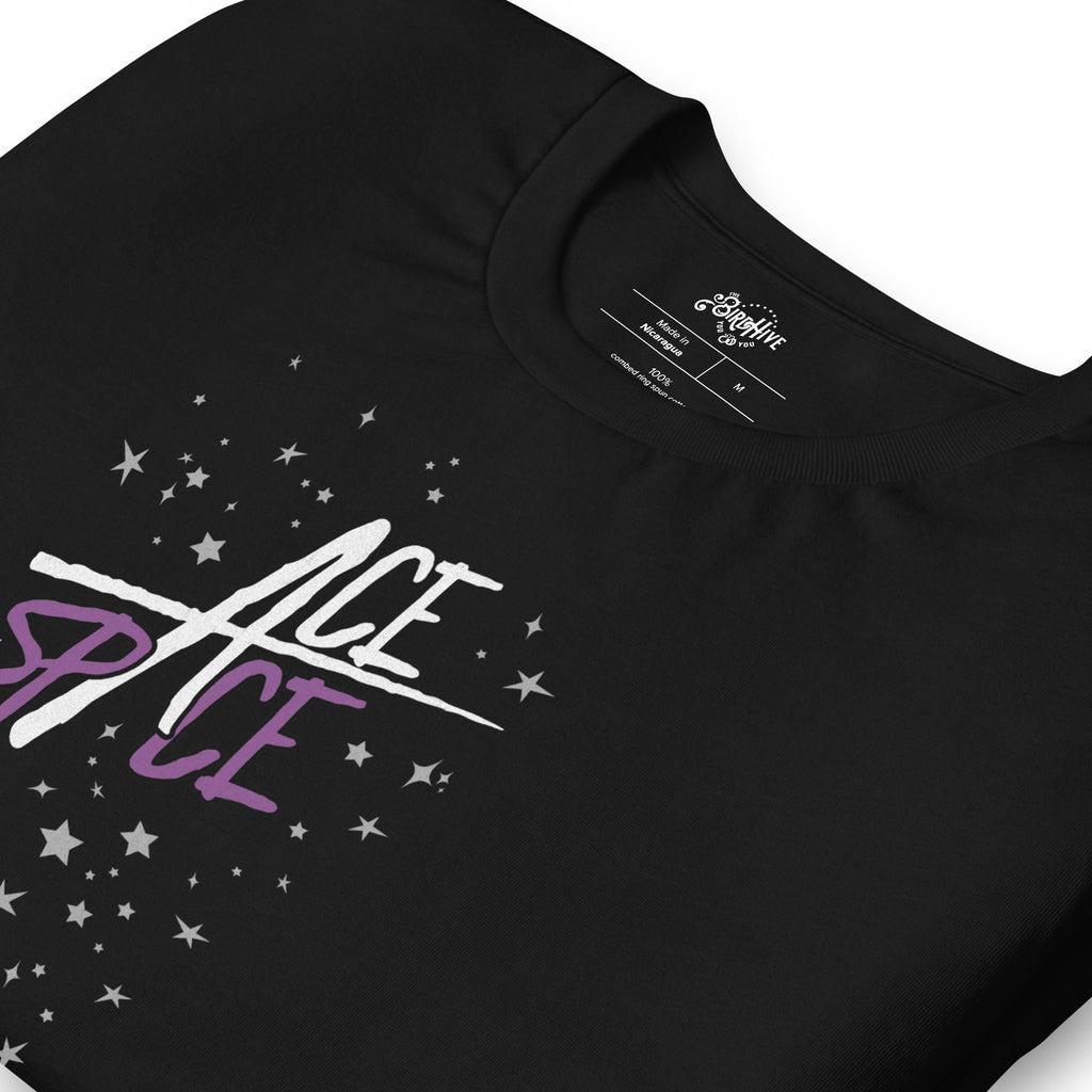 Folded Black Unisex fit Tee with Design on front is  “Ace in this Space” in word art that resembles a star. “Ace” is written in White. “Space” is in purple. “In The” is in gray. There are gray stars sporadically placed around the word art. This design is on a black background to include all colors of the Asexual pride flag.