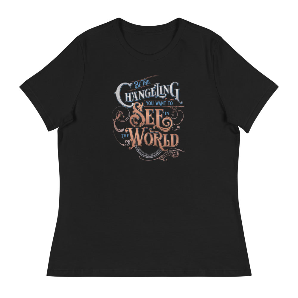 Black fem relaxed fit Tee with the  Word art of “Be the Changeling you want to see in the world” in silver, bronze and blue lettering surrounded by intricate decals