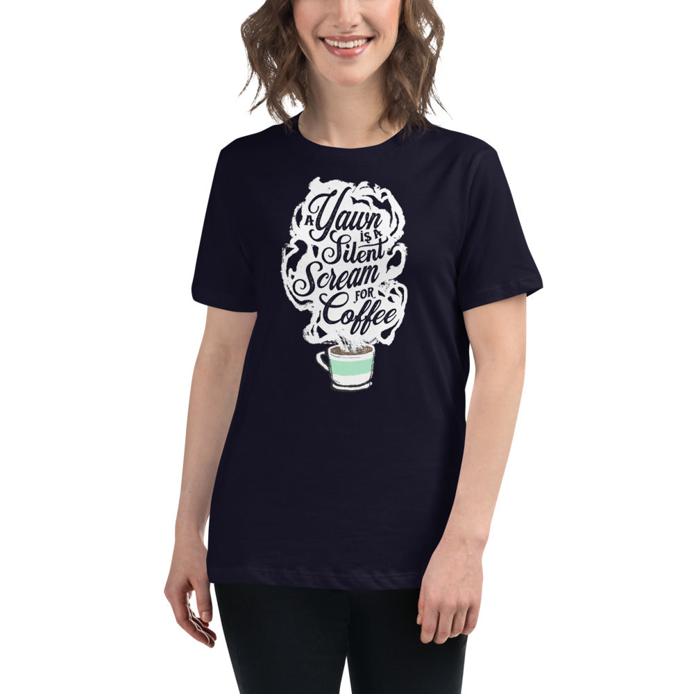 Image of brunette white woman wearing Navy blue Fem relaxed fit Tee with White coffee cup with green stripe filled with hot coffee that is releasing white steam. "A Yawn is a Silent Scream for Coffee" written in the steam. 